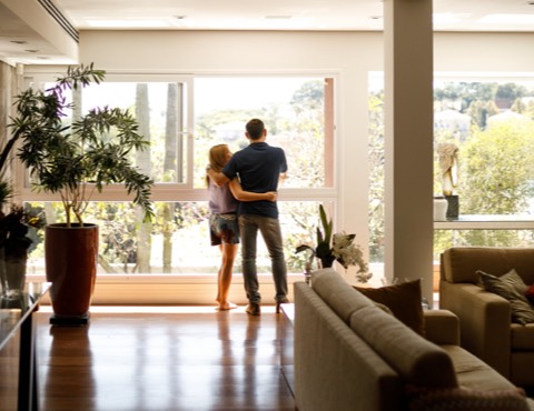 A young couple embracing in a modern house